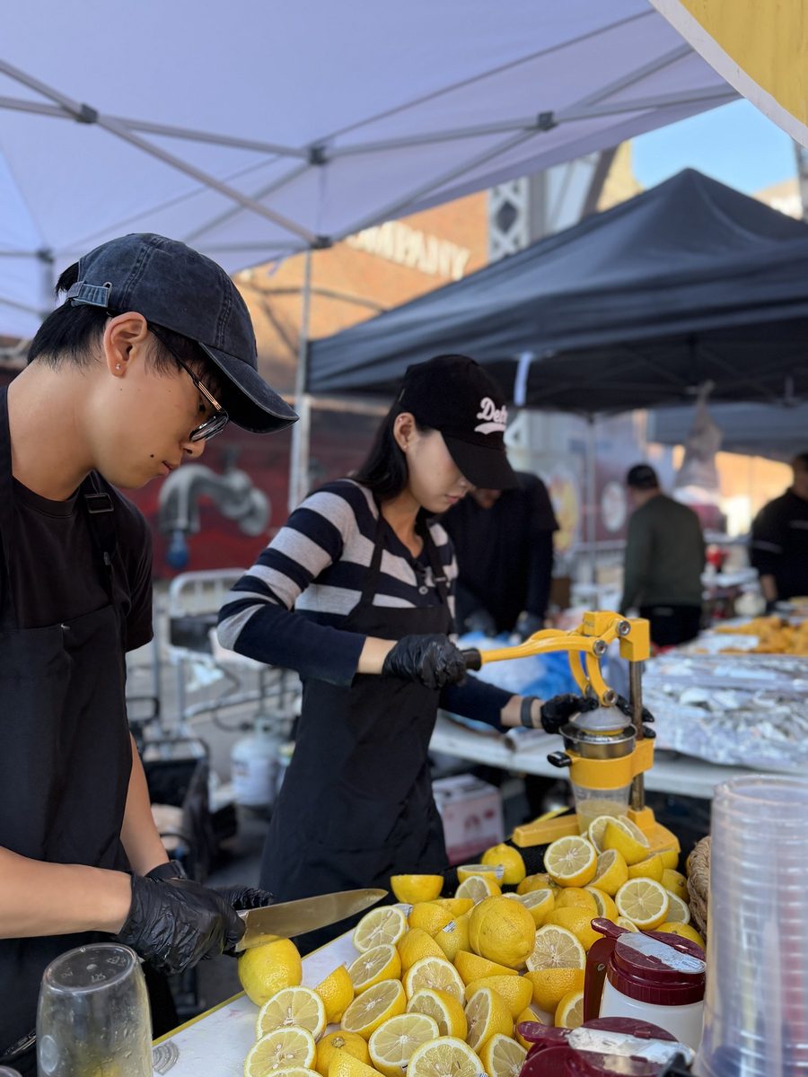 Fresh lemons being pressed at a lemonade stand