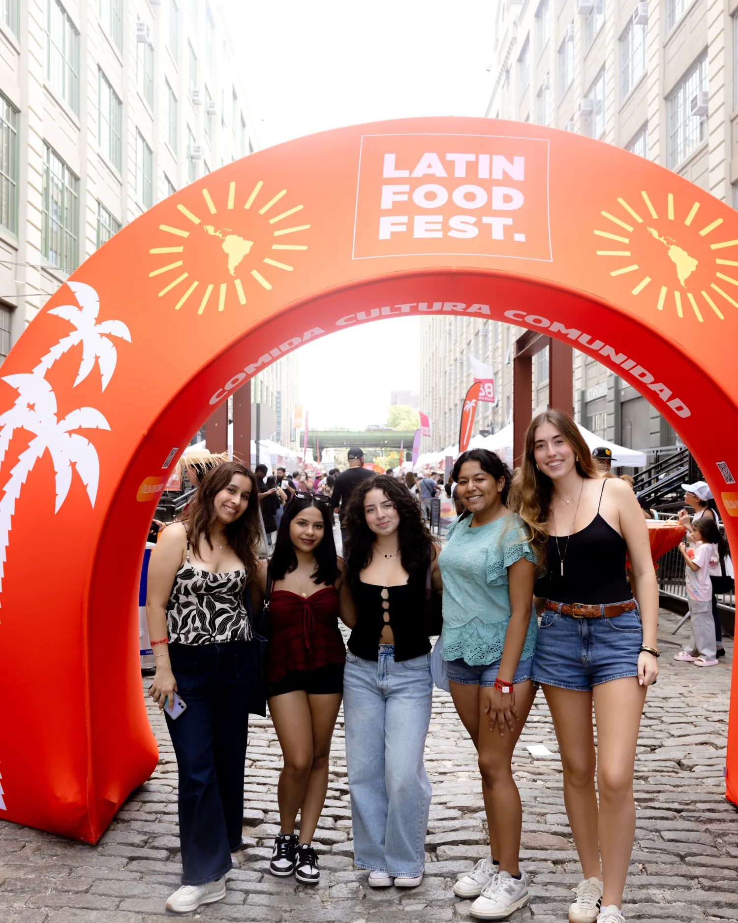 Friends under the Latin Food Fest entrance arch