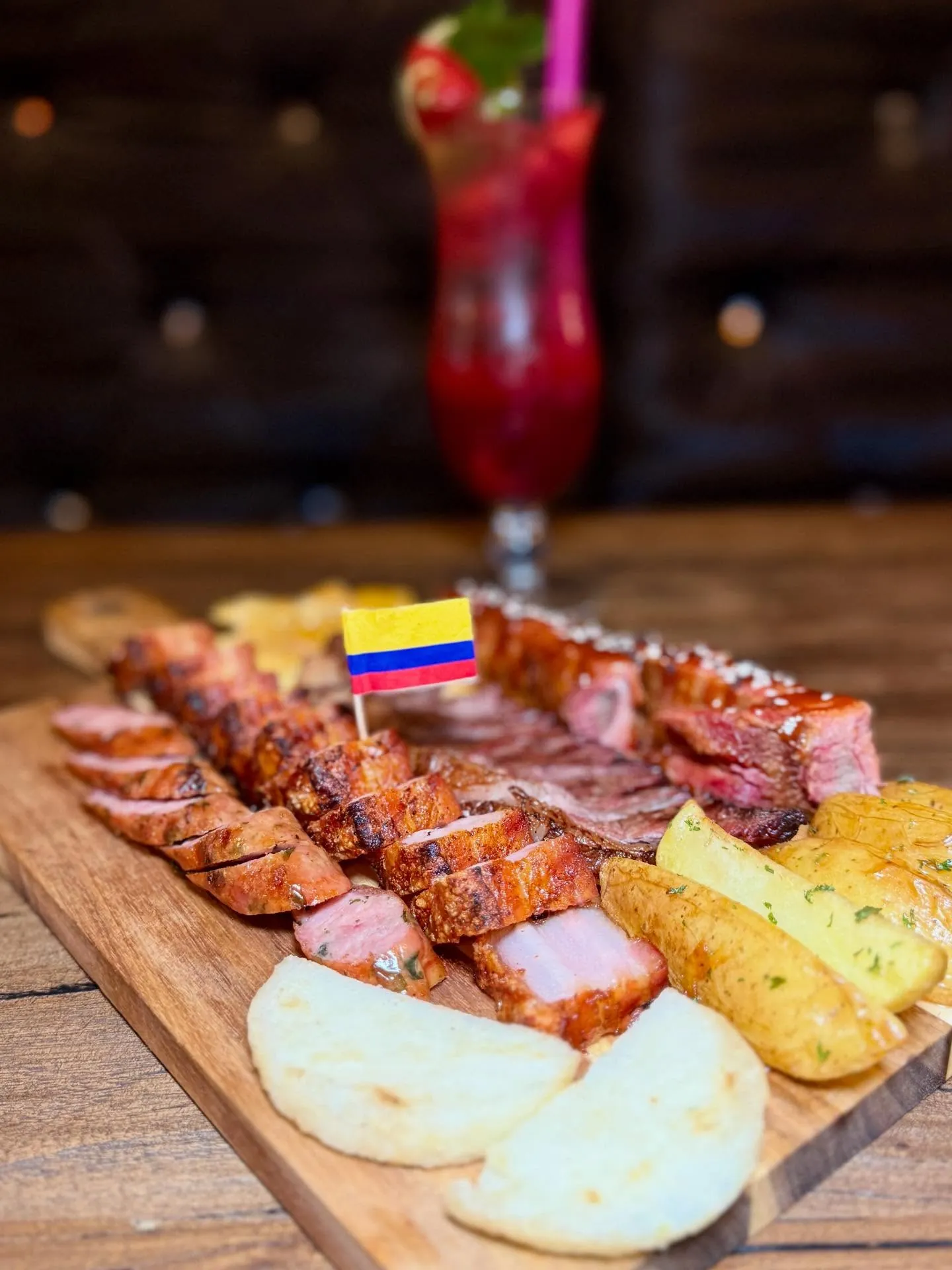 Colombian grilled meat board with a flag pick